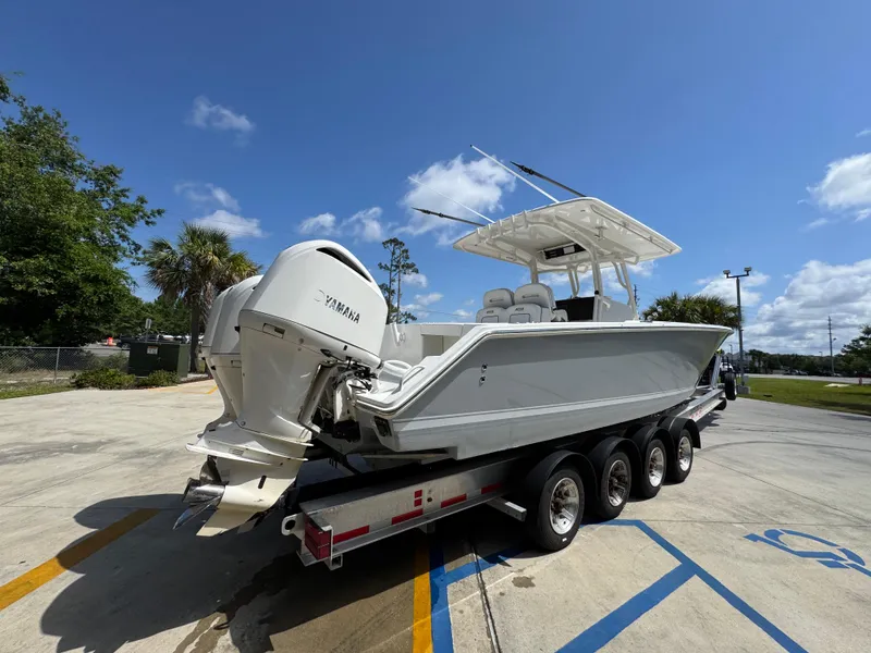 Slide: The Image of 2018 Jupiter 34 HFS boat on trailer with Yamaha engine, parked outdoors. - 12
