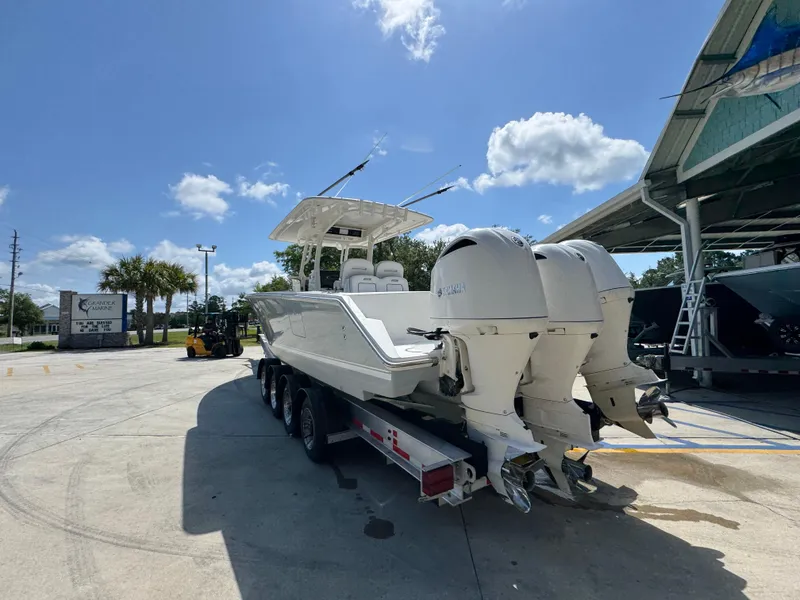 Slide: The Image of 2018 Jupiter 34 HFS boat on trailer under clear blue sky. - 16