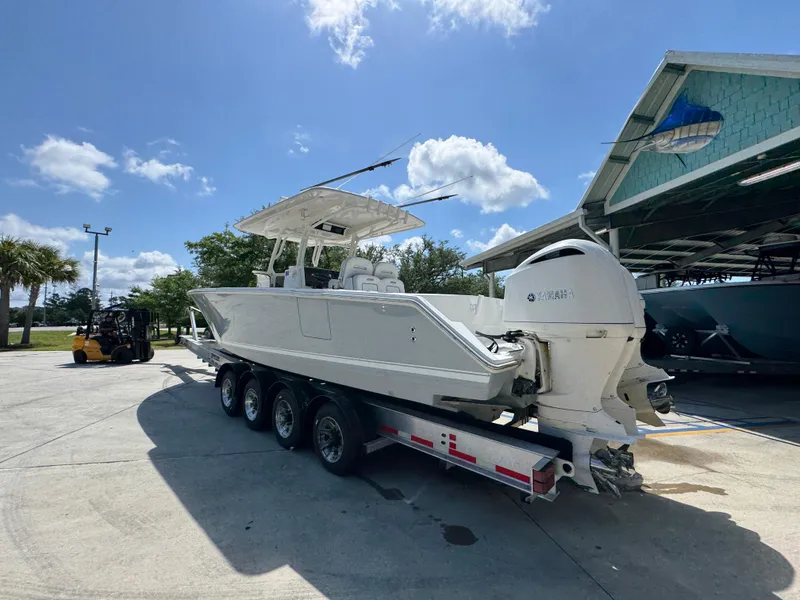 Slide: The Image of 2018 Jupiter 34 HFS boat on trailer under clear blue sky. - 17