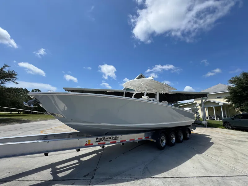 Slide: The Image of 2018 Jupiter 34 HFS boat on trailer under blue sky. - 2