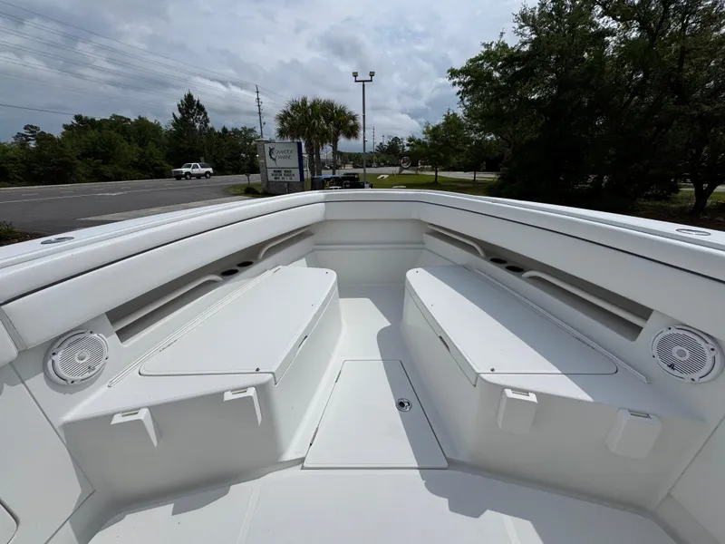 Slide: The Image of 2018 Jupiter 34 HFS boat interior with white seating and speakers. - 20