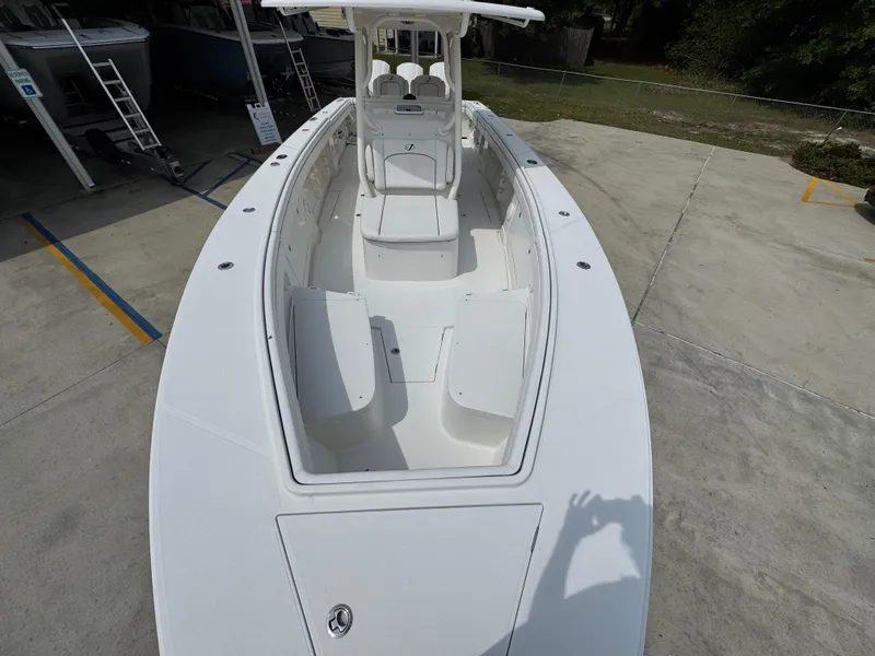 Slide: The Image of 2018 Jupiter 34 HFS boat, white exterior, docked on concrete surface, viewed from above. - 21