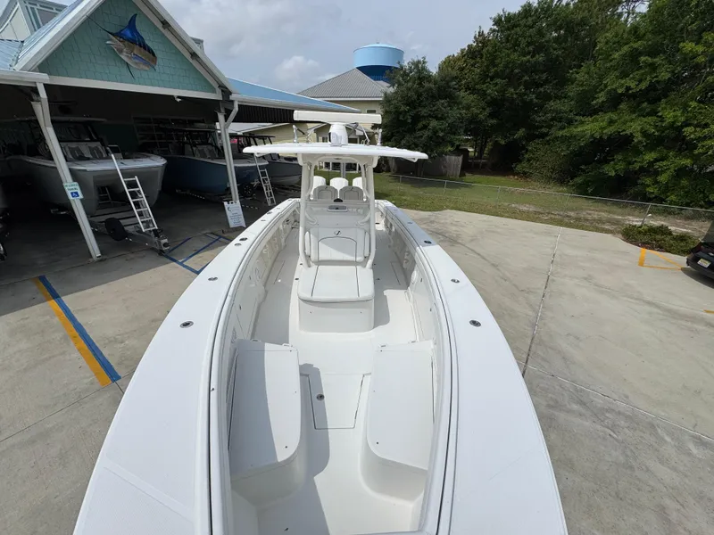 Slide: The Image of 2018 Jupiter 34 HFS boat docked at a marina with trees in the background. - 22