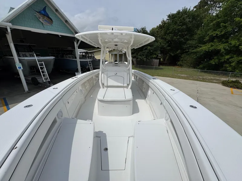 Slide: The Image of 2018 Jupiter 34 HFS boat with spacious deck and center console, parked outdoors. - 23