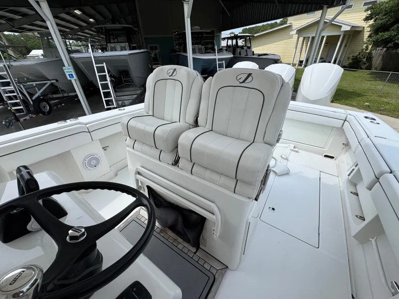 Slide: The Image of 2018 Jupiter 34 HFS boat interior with dual captain's chairs and steering wheel. - 27