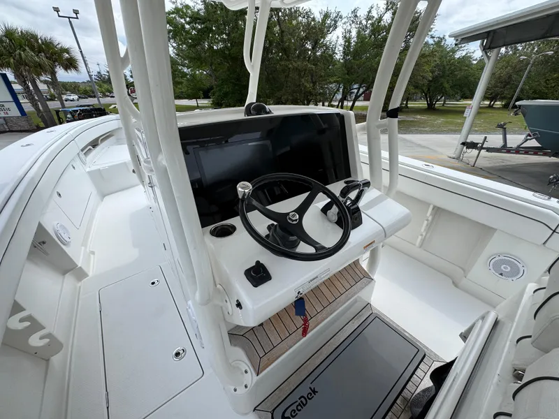 Slide: The Image of 2018 Jupiter 34 HFS boat helm with steering wheel and navigation display. - 29