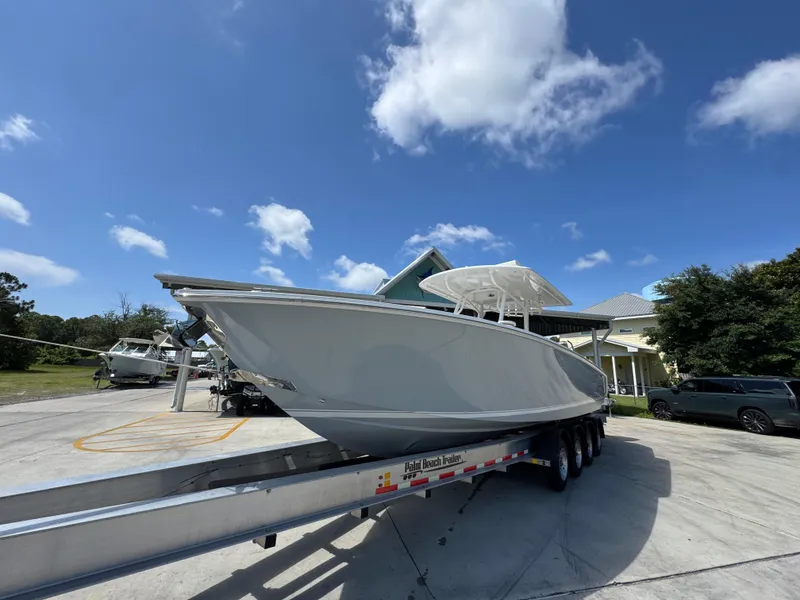Slide: The Image of 2018 Jupiter 34 HFS boat on trailer under blue sky. - 3