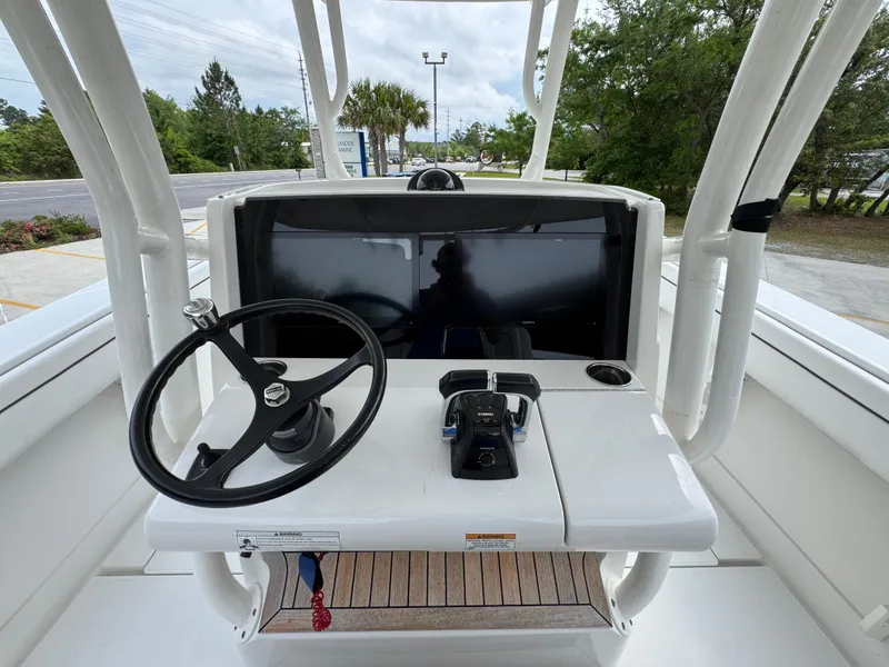 Slide: The Image of 2018 Jupiter 34 HFS boat helm with steering wheel and controls. - 30