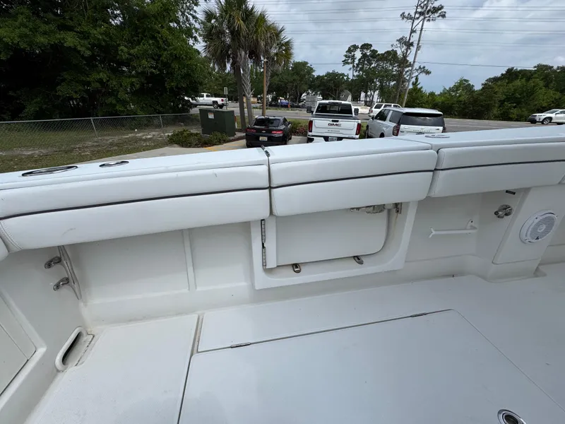 Slide: The Image of 2018 Jupiter 34 HFS boat interior with white cushioned seating and storage compartments. - 34