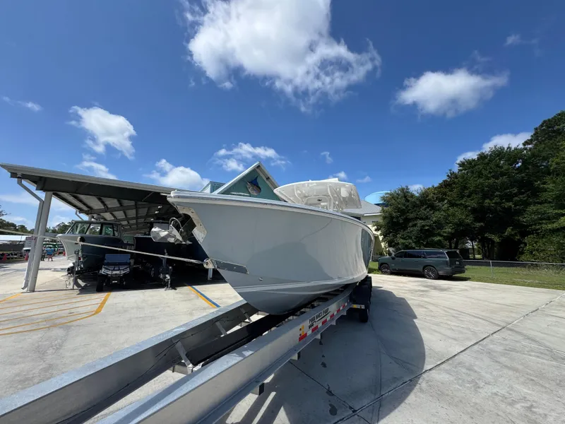 Slide: The Image of 2018 Jupiter 34 HFS boat on trailer under clear blue sky. - 4