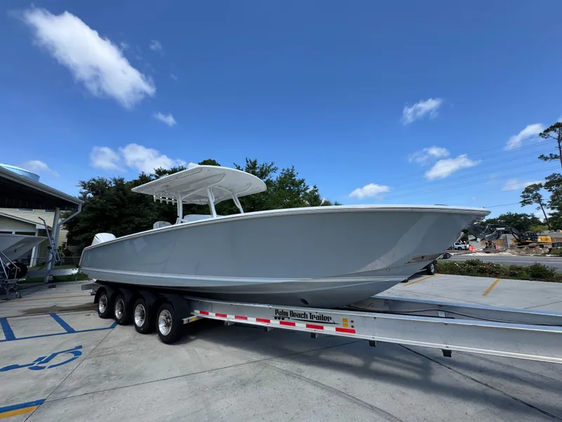 Slide: The Image of 2018 Jupiter 34 HFS boat on trailer under clear blue sky. - 8