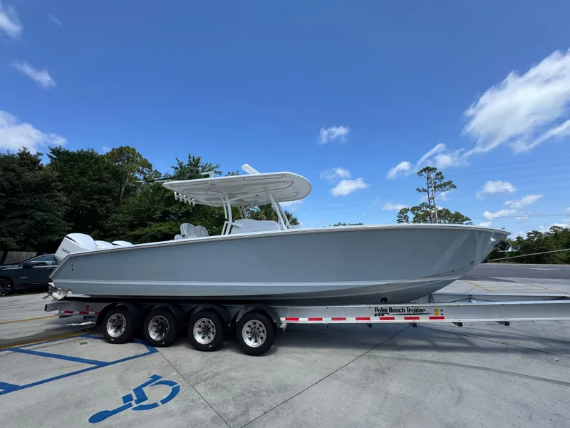 Slide: The Image of 2018 Jupiter 34 HFS boat on trailer under clear blue sky. - 9