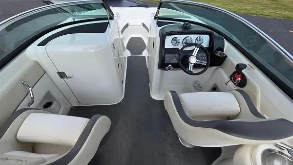 Slide: The Image of 2013 Sea Ray 240 Sundeck interior with steering wheel and seating. - 3