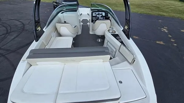 Slide: The Image of 2013 Sea Ray 240 Sundeck boat interior with white seating and dashboard view. - 4