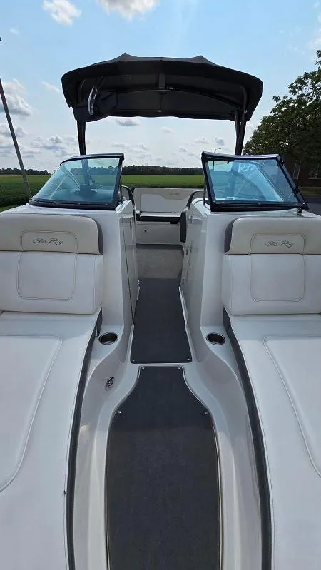 Slide: The Image of 2013 Sea Ray 240 Sundeck boat interior with dual windshields and seating. - 6