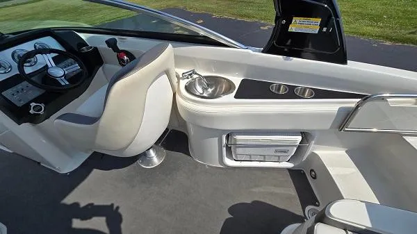 Slide: The Image of 2013 Sea Ray 240 Sundeck interior with helm, sink, and seating area. - 7