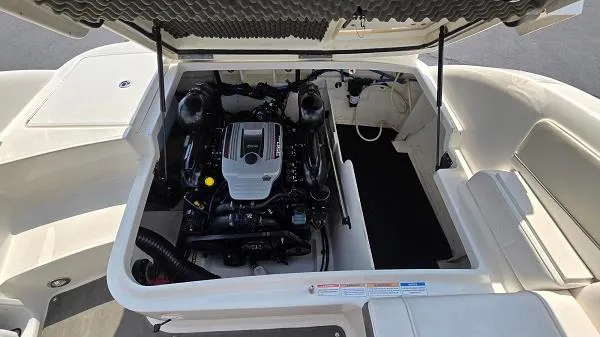 Slide: The Image of 2013 Sea Ray 240 Sundeck engine compartment, showcasing the boat's powerful motor. - 8