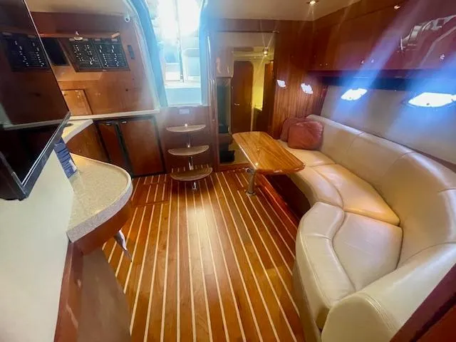 Slide: The Image of Luxurious interior of 2011 Regal 46 Sport Coupe with wooden flooring and plush seating. - 12