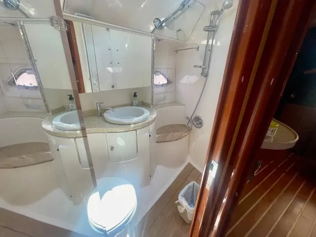 Slide: The Image of Luxurious bathroom in 2011 Regal 46 Sport Coupe yacht with dual sinks and shower. - 14