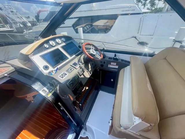 Slide: The Image of 2011 Regal 46 Sport Coupe helm with modern controls and beige seating. - 23