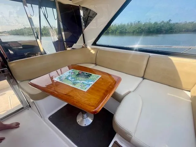 Slide: The Image of Interior of 2011 Regal 46 Sport Coupe with beige seating and wooden table. - 26