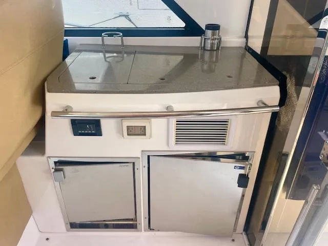 Slide: The Image of 2011 Regal 46 Sport Coupe yacht interior with kitchenette and appliances. - 27