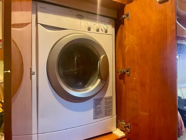Slide: The Image of Washing machine inside a wooden cabinet on a 2011 Regal 46 Sport Coupe yacht. - 3