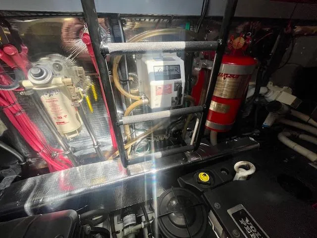 Slide: The Image of Engine room of a 2011 Regal 46 Sport Coupe with visible components and fire extinguisher. - 35