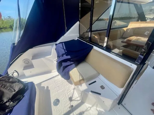 Slide: The Image of 2011 Regal 46 Sport Coupe boat interior with seating and blue cover. - 42