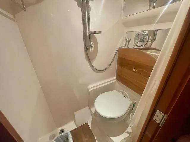 Slide: The Image of 2011 Regal 46 Sport Coupe bathroom with shower and toilet, compact and modern design. - 5