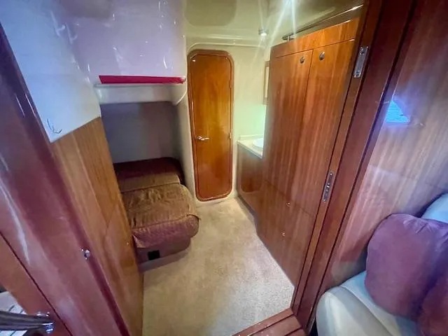 Slide: The Image of 2011 Regal 46 Sport Coupe interior with wood finish and cozy cabin space. - 7