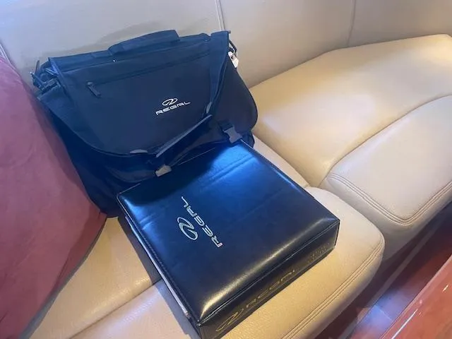 Slide: The Image of Black Regal bag and binder on beige boat seating, 2011 Regal 46 Sport Coupe. - 8