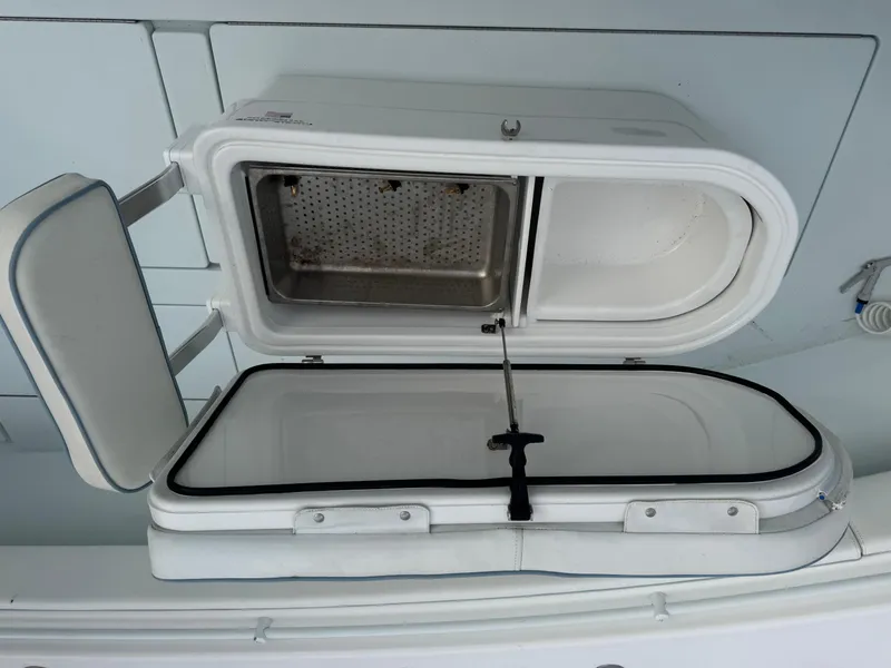 Slide: The Image of 2019 Contender 35 ST boat storage compartment with open hatch, showcasing interior design. - 12