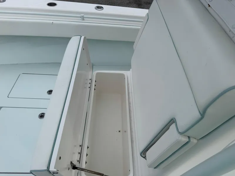 Slide: The Image of 2019 Contender 35 ST boat interior with open storage compartment and cushioned seating. - 13