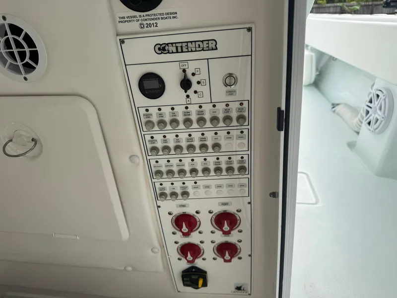 Slide: The Image of Control panel of a 2019 Contender 35 ST boat with switches and dials. - 14