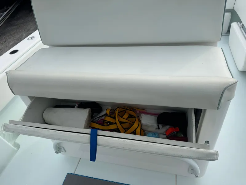 Slide: The Image of Storage compartment on a 2019 Contender 35 ST boat, containing various items. - 17