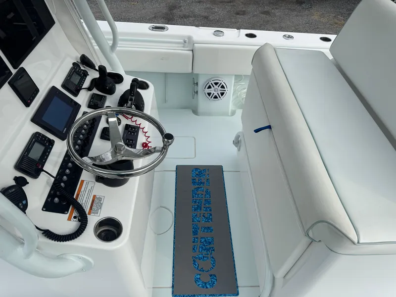 Slide: The Image of 2019 Contender 35 ST boat cockpit with steering wheel and control panel. - 18
