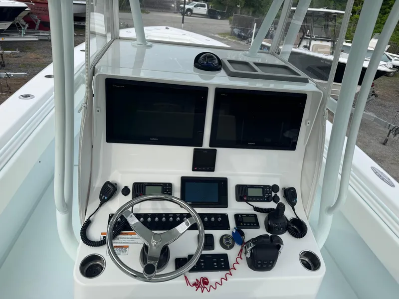 Slide: The Image of 2019 Contender 35 ST boat dashboard with dual screens and navigation controls. - 19