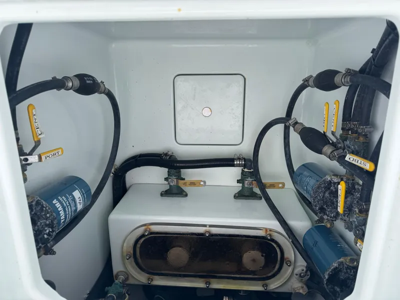 Slide: The Image of 2019 Contender 35 ST boat compartment with hoses and valves. - 2