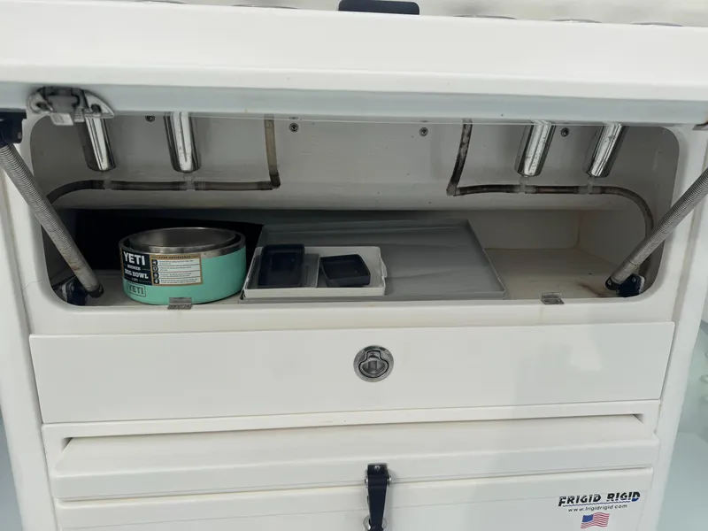 Slide: The Image of 2019 Contender 35 ST storage compartment with Yeti cup and accessories. - 21