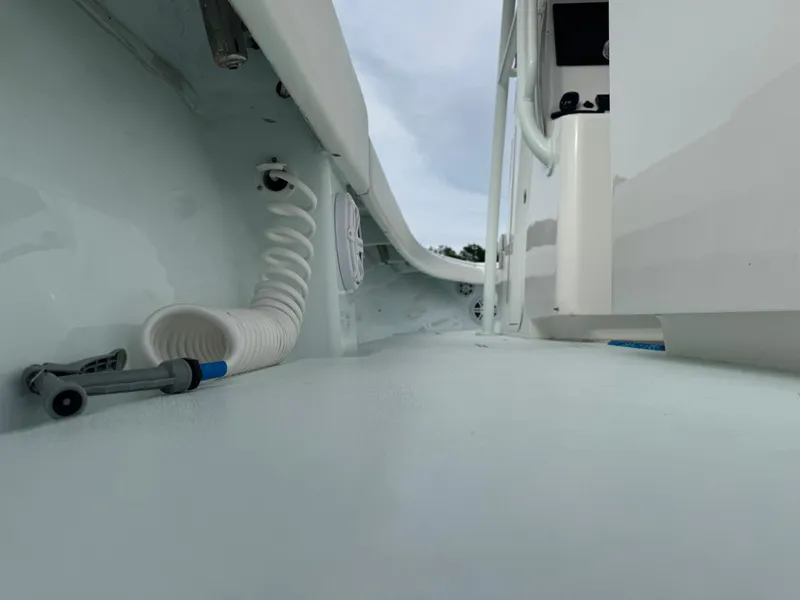 Slide: The Image of 2019 Contender 35 ST boat interior with coiled hose and clean deck. - 23
