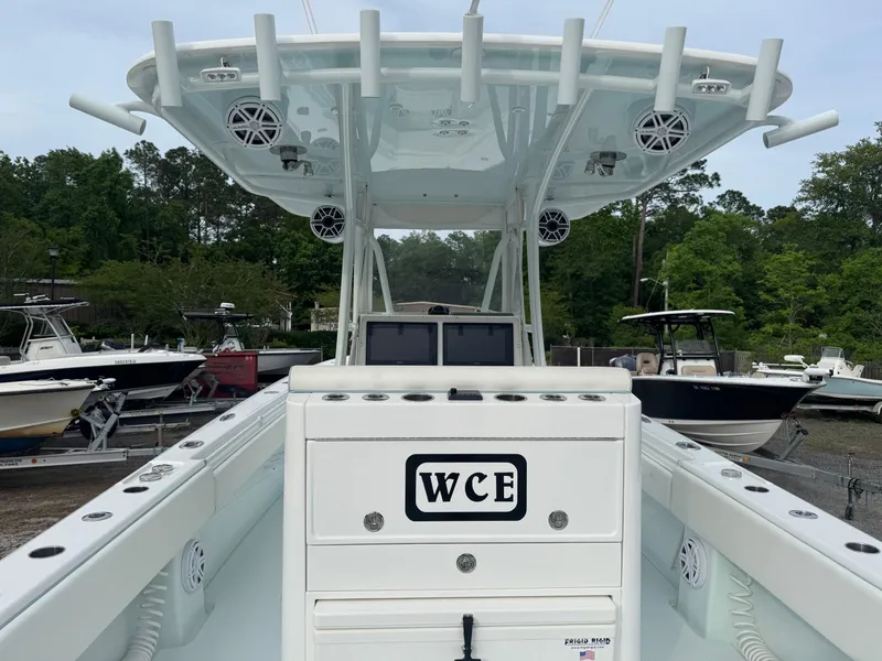 Slide: The Image of 2019 Contender 35 ST boat with center console and rod holders, docked outdoors. - 28