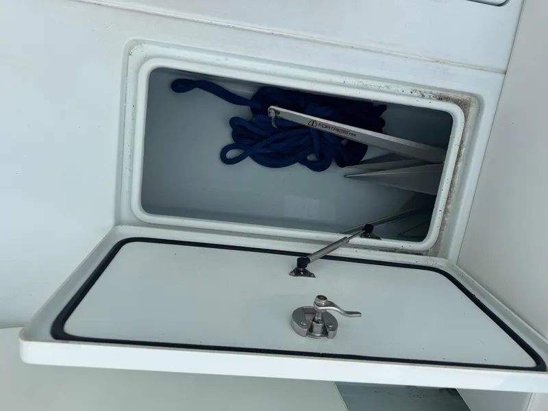 Slide: The Image of Open storage compartment on 2019 Contender 35 ST boat with blue rope inside. - 3