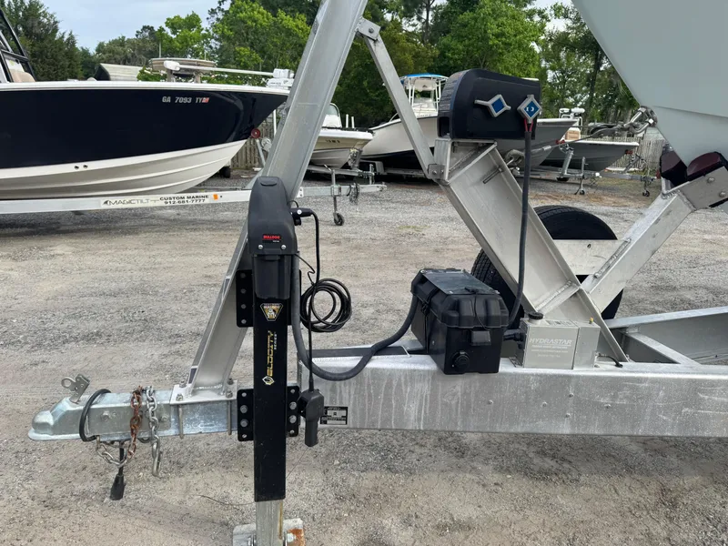 Slide: The Image of Trailer hitch of a 2019 Contender 35 ST boat in a parking area. - 32