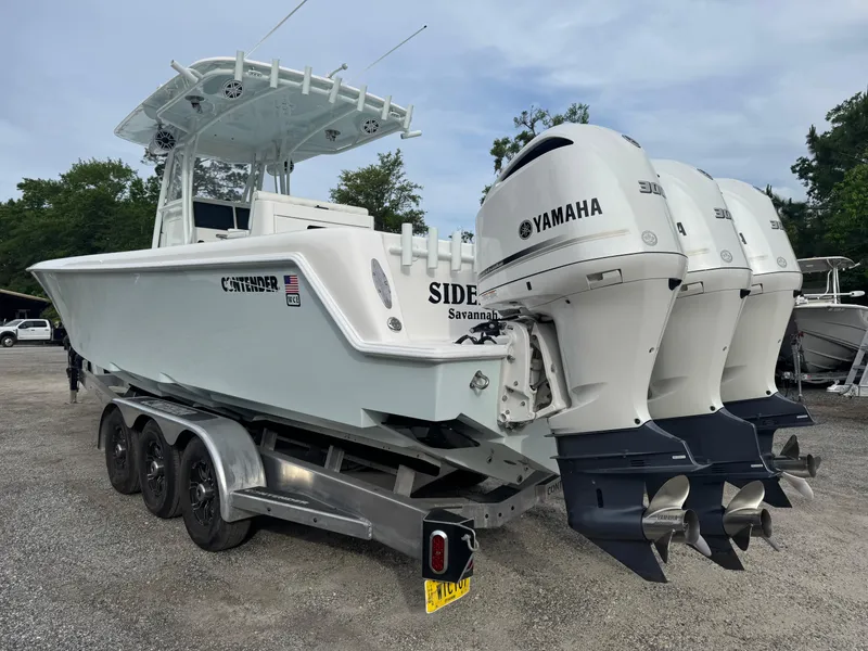 Slide: The Image of 2019 Contender 35 ST boat with triple Yamaha engines on a trailer. - 34