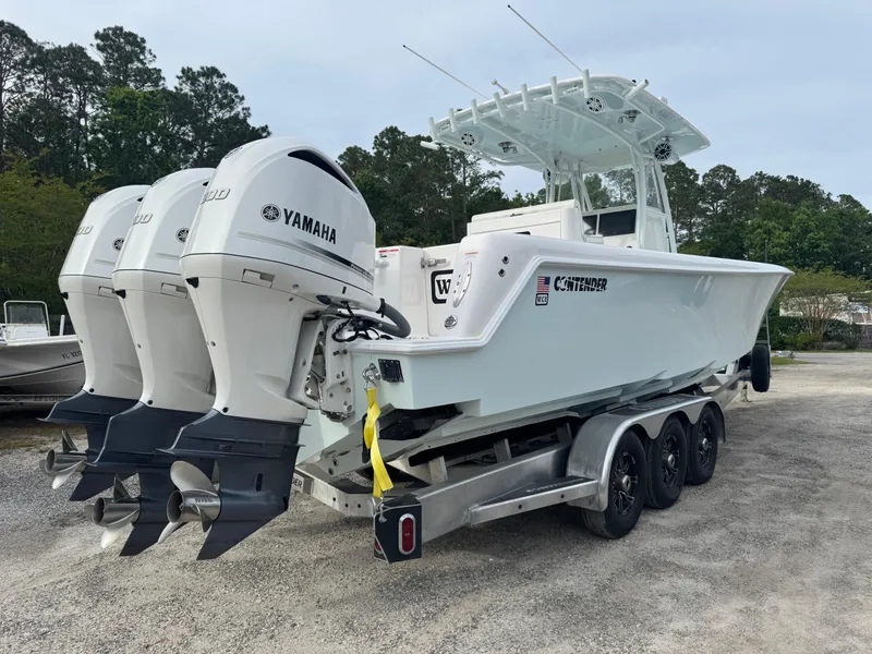 Slide: The Image of 2019 Contender 35 ST boat with triple Yamaha engines on a trailer. - 37