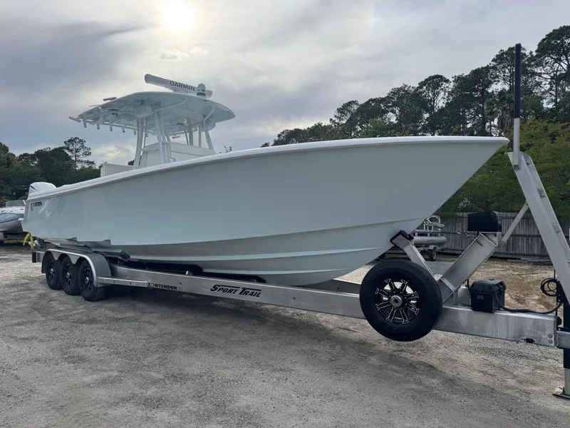 Slide: The Image of 2019 Contender 35 ST boat on trailer, parked outdoors under cloudy sky. - 39