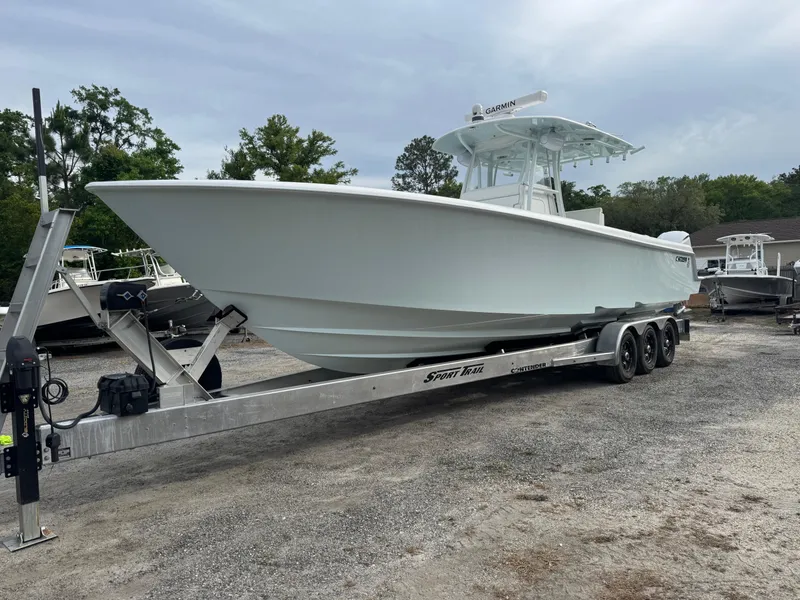 Slide: The Image of 2019 Contender 35 ST boat on trailer, parked outdoors, with overcast sky. - 40