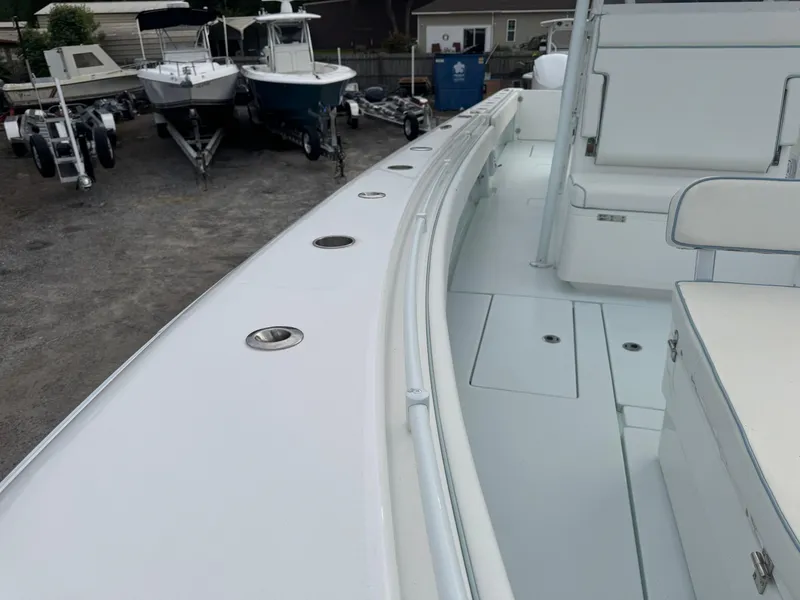Slide: The Image of 2019 Contender 35 ST boat deck with seating, docked alongside other boats. - 6