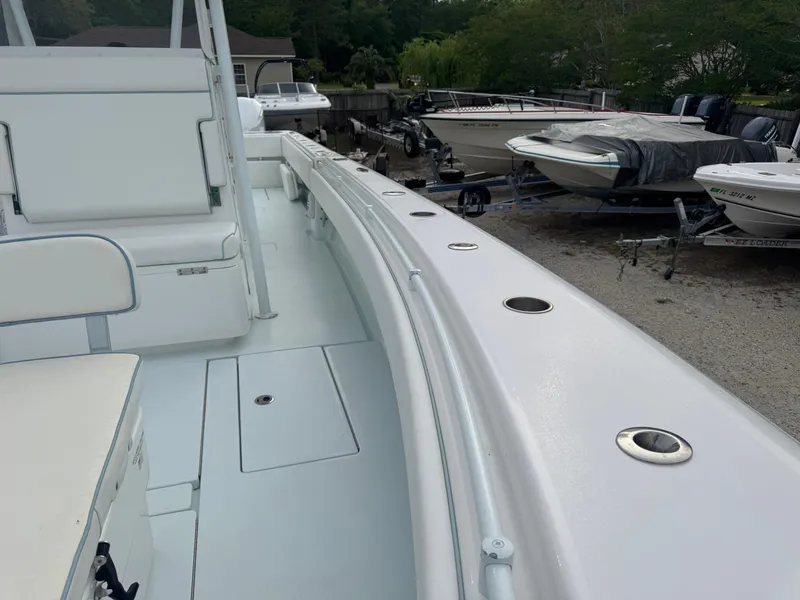 Slide: The Image of 2019 Contender 35 ST boat interior with rod holders, docked among other boats. - 7